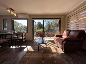 a living room with a couch and a dining table at mirabosque aparment ejecutivo 5 in Osorno