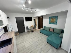 a living room with a green couch and a table at 1 Mai - Luxury Park Apartments - Self Check-in - Private parking - 2 in Craiova