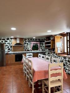 a kitchen with a table and chairs in a room at Casa Rural Juanbarterena in Ulzurrun