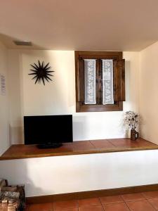 a room with a flat screen tv and a window at Casa Rural Juanbarterena in Ulzurrun