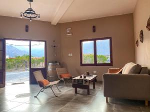 a living room with a couch and chairs and a table at Posada del Musiquero in Cafayate