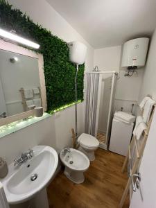 uma casa de banho com um lavatório, um WC e um espelho. em GeLiRó Apartment Catania Centro em Catânia