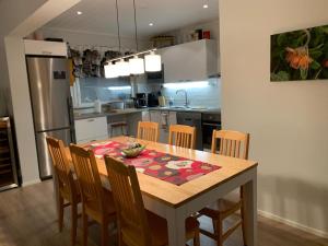 a kitchen with a wooden table with chairs and a dining room at Rovaniemi city Apartment in Rovaniemi +8 photos