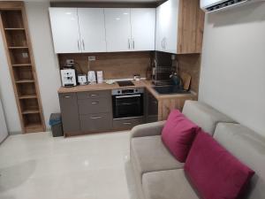 a living room with a couch and a kitchen at Downtown in Ruse +10 photos