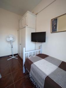 a bedroom with a bed and a flat screen tv at Namoro alojamientos in Mar del Plata