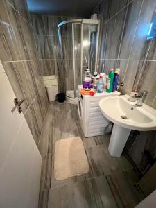 a small bathroom with a sink and a shower at Entire house 2 bedrooms, 1 dbl 1 bunk bed, private garden, pool and secure in Antalya