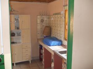 a small kitchen with a counter and a sink at Camping-Sukuta & Lodge in Sukuta