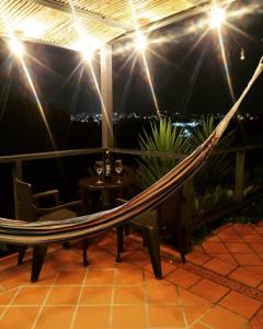 a hammock on a balcony with a view of the city at San José de las bromelias in Marinilla