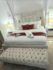 a bedroom with a large white bed with a foot board at 3 BDR Luxurious Villa in Milimani Kisumu in Kisumu