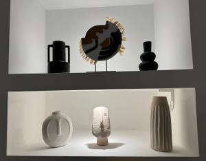 two shelves with vases and other items on them at The Place in Bologna
