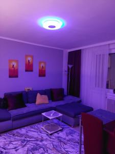 a purple living room with a couch and a table at NB Royal in Vienna