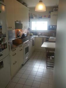 a kitchen with a sink and a table in it at Room cosycosy in Clichy