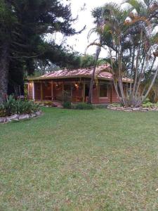 a house with a yard in front of it at Beautiful Country House located in Llanogrande in Rionegro