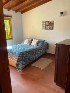 a bedroom with a bed with pillows on it at Beautiful Country House located in Llanogrande in Rionegro