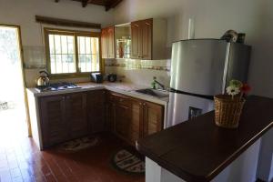 a kitchen with a refrigerator and a counter top at Beautiful Country House located in Llanogrande in Rionegro