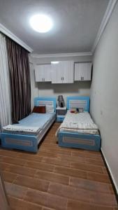 two beds sitting in a room with at G&19 Apartment in Addis Ababa
