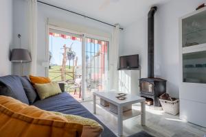 ein Wohnzimmer mit einem Sofa und einem Kamin in der Unterkunft Adosado Cigüeñas IV-Islantilla Golf in Huelva