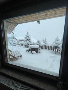 a window view of a yard covered in snow at Villa 80 Kodra e Diellit in Tetovo