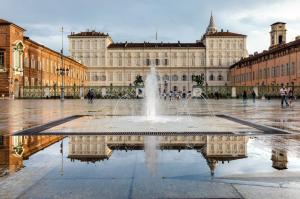 a fountain in front of a large building at XX SETTEMBRE Urban Relais in Turin