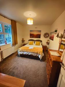 a bedroom with a bed and a dresser at Holme Lea, Ingleton, North Yorkshire in Ingleton 