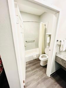 uma casa de banho com um WC e uma banheira em Garden Suites em La Porte