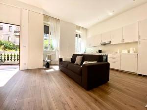 a living room with a couch and a kitchen at Apartment in Brera Milan in Milan