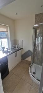 a bathroom with a shower and a sink at Holme Lea, Ingleton, North Yorkshire in Ingleton 