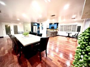 a dining room and living room with a table and chairs at Central Location Family Size Home in Temple City
