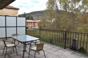 a table and chairs sitting on a balcony with a view at VUT PINARES DE SORIA in Molinos de Duero