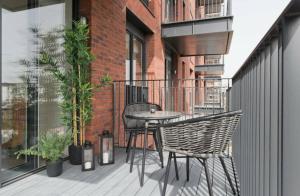 a patio with a table and chairs on a balcony at Luxury Apartment in London in London