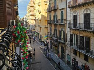 a city street with buildings and people walking on the street at Teatro Del Sole Maqueda in Palermo