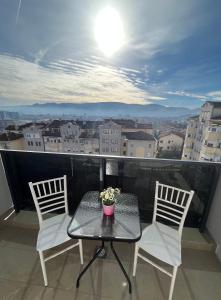 a table and chairs on a balcony with a view at Apartman Vista Banja Luka in Banja Luka