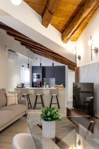 a living room with a couch and a kitchen at Apartamentos Hartzenbusch in Teruel