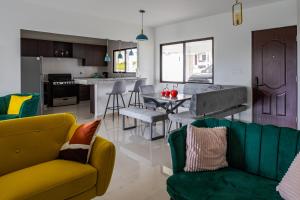a living room and kitchen with yellow and green furniture at Beautiful Family Home in Boquete in Alto Boquete
