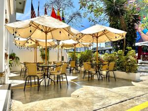 a group of tables and chairs with umbrellas at Virreynal by Maysa in Lima