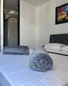 a pillow sitting on top of a bed at Casa Familiar in Armenia