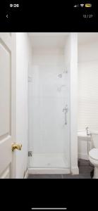 a bathroom with a shower and a toilet at SUITE Dreams CARROLL 11 in Paterson