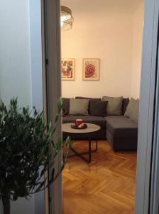 una sala de estar con un sofá y una mesa en Parthenon retreat, en Atenas
