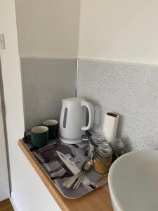 a kitchen counter with a coffee maker on a tray at 1 Luxurious Double Bedroom with Private Shower in Reading