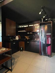 a kitchen with a refrigerator in the middle of it at Flat a beira mar Recife in Recife