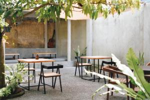 a group of tables and chairs in a courtyard at Plan B Coliving & Coworking in Weligama