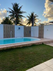 a swimming pool in the backyard of a house at Casa Arembepe in Camaçari