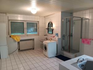 een badkamer met een douche en een wasmachine bij AH G3 OG in Schwalmtal
