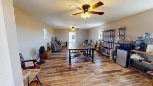 a living room with a ceiling fan and a table at The Barn Apartment at Parkton Place in Hope Mills