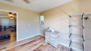 a living room with a ladder and a wooden floor at The Barn Apartment at Parkton Place in Hope Mills