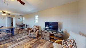 a living room with a flat screen tv and a desk at The Barn Apartment at Parkton Place in Hope Mills