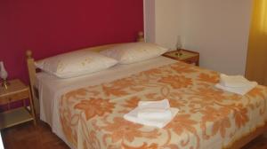 a bedroom with a bed with two towels on it at Apartment Anita in Vodice