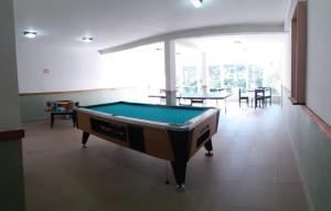 a pool table in the middle of a room at depto pinamar in Pinamar