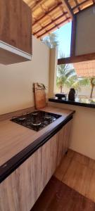 a kitchen with a stove and a counter top at Chalé Brisas do Rio in Petrolina