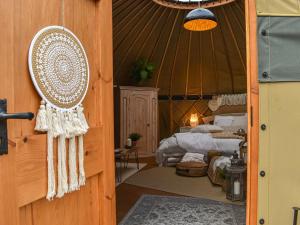 a room with a bed in a yurt at Little West View in Chard